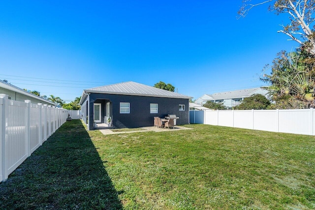 back of property featuring a yard and a patio