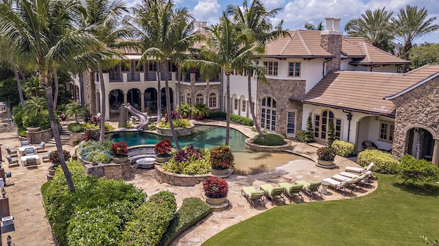 view of pool featuring a yard and a water slide