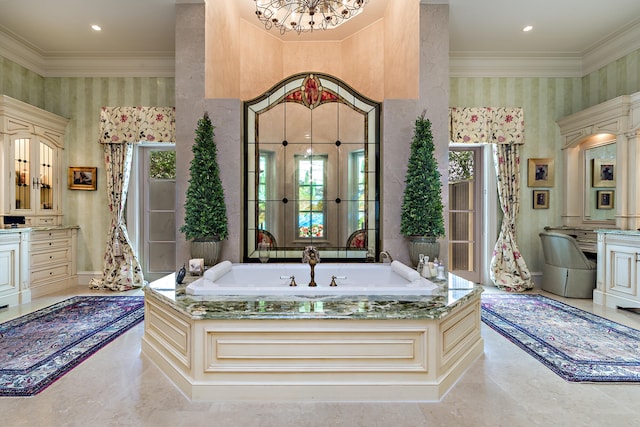 bathroom featuring a chandelier, vanity, a tub, and crown molding