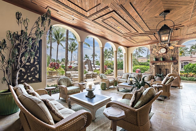 view of patio with an outdoor living space with a fireplace