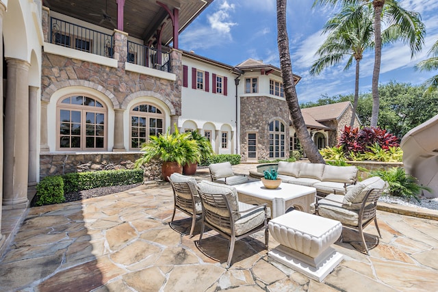 view of patio featuring an outdoor living space and a balcony