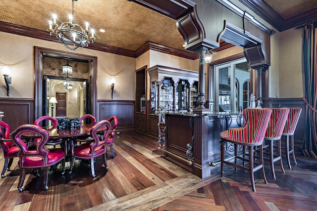 interior space featuring dark brown cabinetry, ornamental molding, and a chandelier