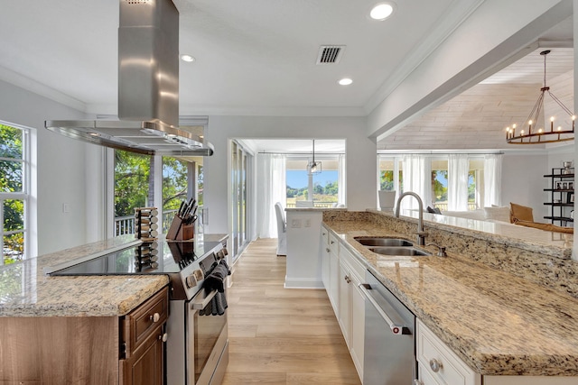 kitchen featuring island range hood, white cabinetry, stainless steel appliances, and a wealth of natural light