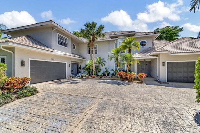 view of front of property featuring a tiled roof and decorative driveway