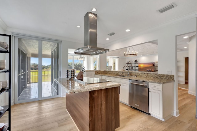 kitchen featuring kitchen peninsula, island exhaust hood, stainless steel dishwasher, light hardwood / wood-style floors, and white cabinetry