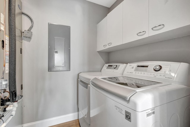 11839 Pebblewood Dr, Wellington, FL 33414 - laundry area with baseboards, cabinet space, electric panel, and washer and dryer
