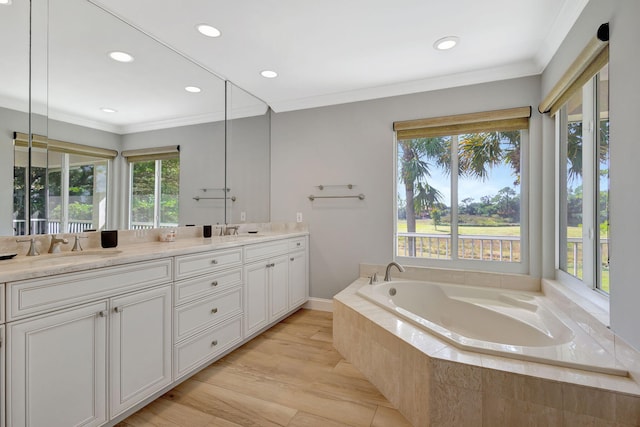 11839 Pebblewood Dr, Wellington, FL 33414 - bathroom with double vanity, ornamental molding, a garden tub, a sink, and recessed lighting