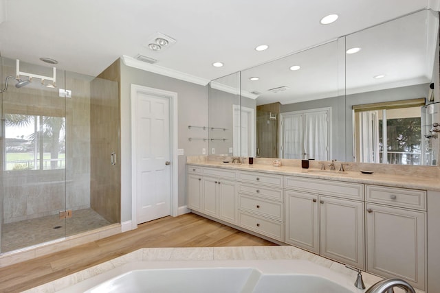 11839 Pebblewood Dr, Wellington, FL 33414 - bathroom with wood finished floors, a sink, visible vents, a shower stall, and double vanity