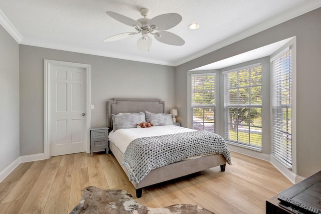 bedroom featuring multiple windows, ceiling fan, and light hardwood / wood-style flooring