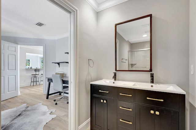 bathroom featuring crown molding, a shower with door, vanity, and wood-type flooring