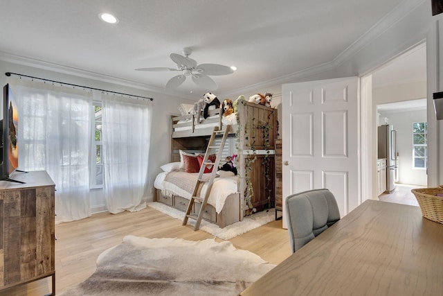 bedroom with ceiling fan, stainless steel fridge, light wood-type flooring, and crown molding