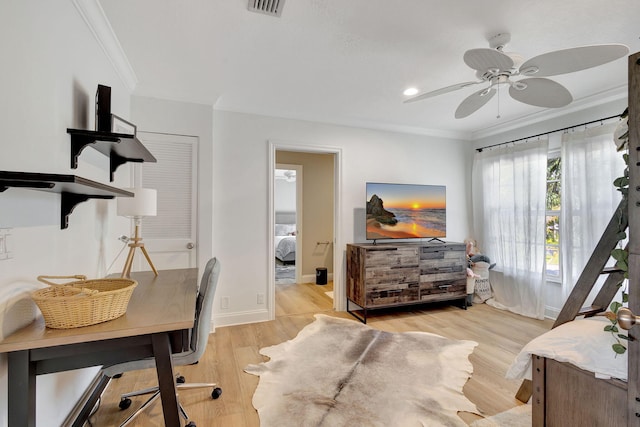 office space featuring ceiling fan, ornamental molding, and light wood-type flooring