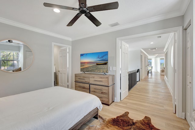 bedroom with light hardwood / wood-style floors, ceiling fan, and ornamental molding