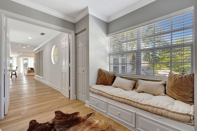 interior space with crown molding and light wood-type flooring