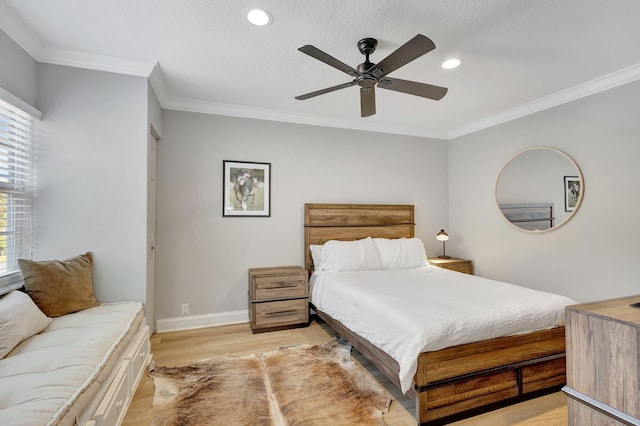 bedroom featuring a textured ceiling, ceiling fan, light wood-type flooring, and crown molding