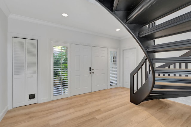 entrance foyer featuring light hardwood / wood-style floors and crown molding