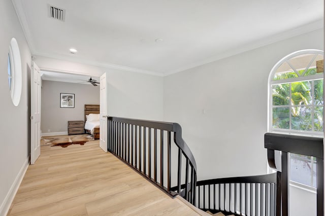 hall featuring crown molding and light wood-type flooring