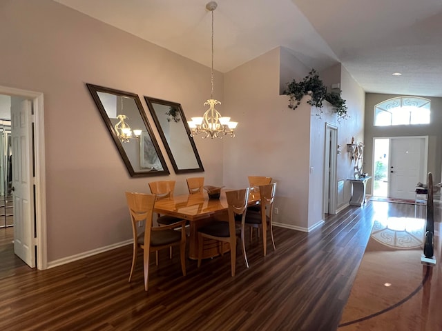 dining room featuring high vaulted ceiling, dark wood-type flooring, and a notable chandelier