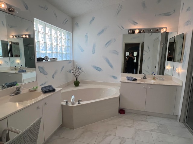 bathroom with vanity, plus walk in shower, and a textured ceiling