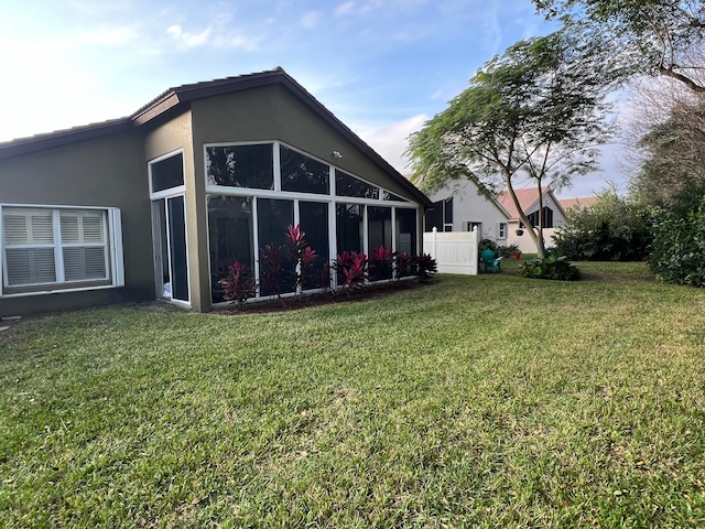 exterior space with a yard and a sunroom