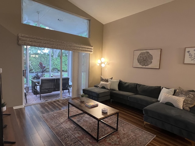 living area with dark wood-style flooring and high vaulted ceiling