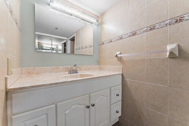 bathroom featuring vanity and tile walls