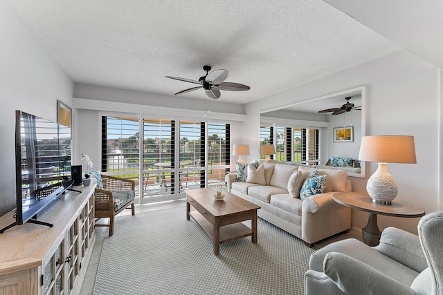 living room with plenty of natural light, a textured ceiling, and light carpet