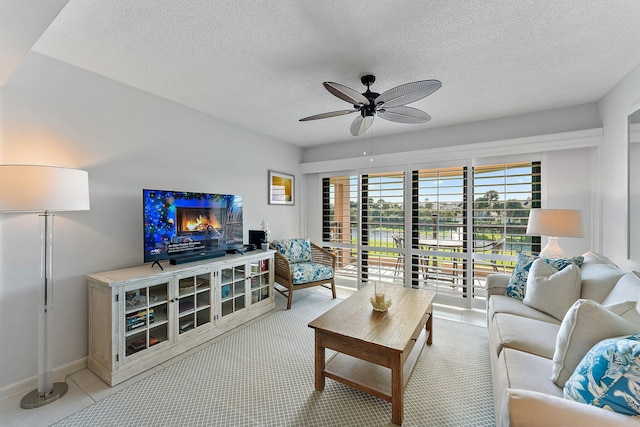 living room with a textured ceiling and ceiling fan