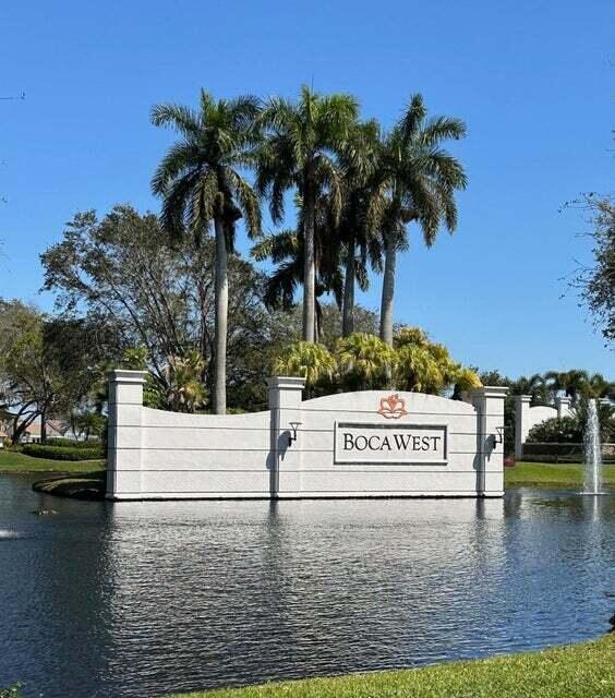 community / neighborhood sign featuring a water view