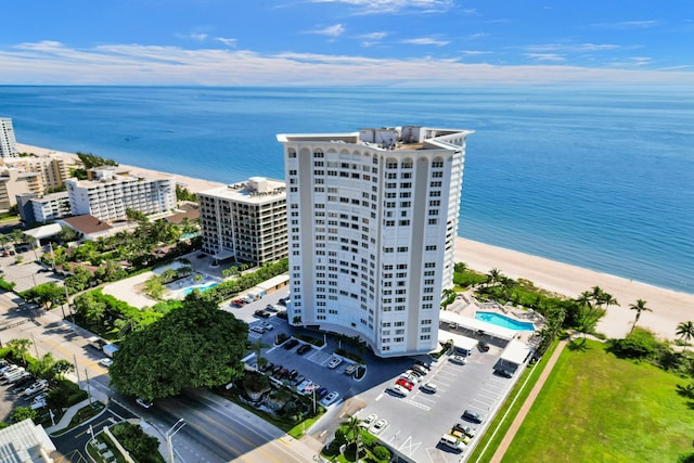 drone / aerial view featuring a water view and a beach view