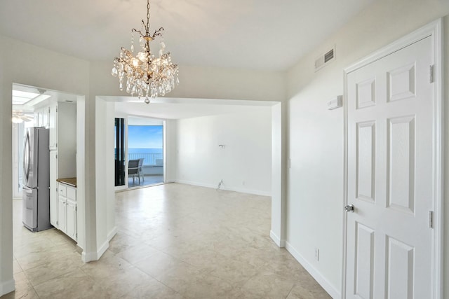 hallway featuring a notable chandelier