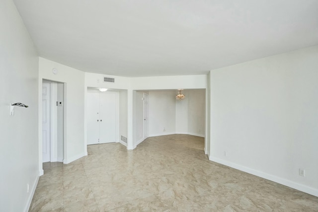 empty room featuring a notable chandelier