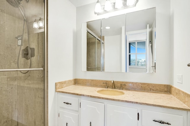 bathroom with vanity and a shower with shower door