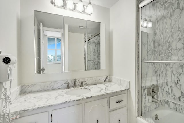 bathroom featuring vanity and shower / bath combination with glass door