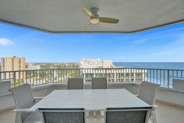 balcony featuring a water view and ceiling fan