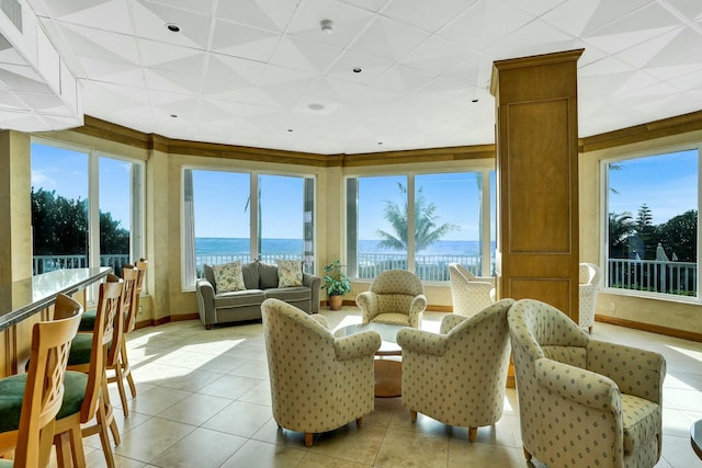 sunroom featuring a water view and a wealth of natural light