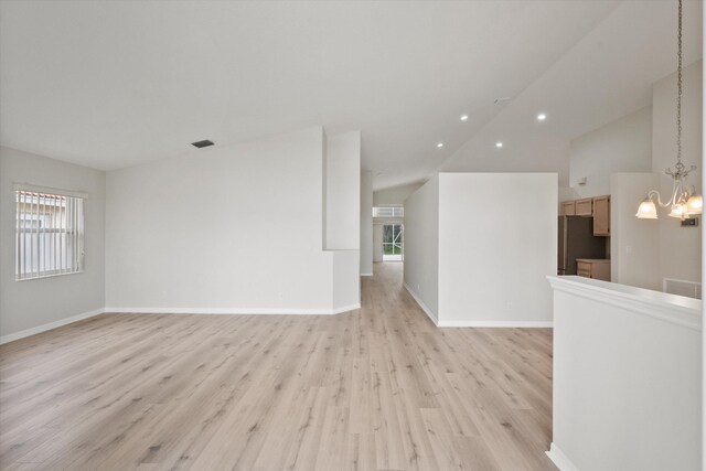 unfurnished living room with light tile patterned floors, ceiling fan, and lofted ceiling