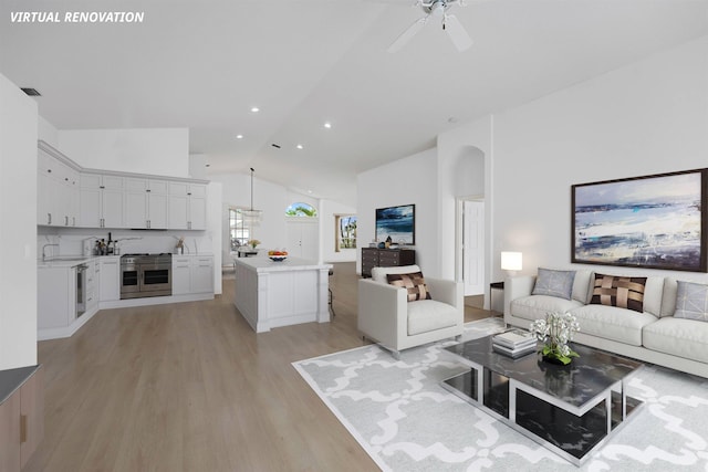 living room with ceiling fan, lofted ceiling, and light hardwood / wood-style floors