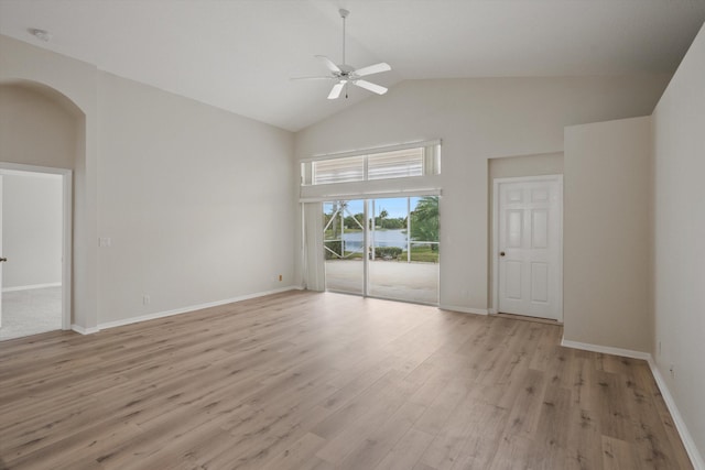 empty room with ceiling fan, high vaulted ceiling, and light hardwood / wood-style floors