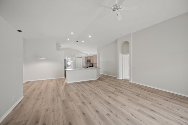 unfurnished living room featuring ceiling fan, vaulted ceiling, and light hardwood / wood-style flooring