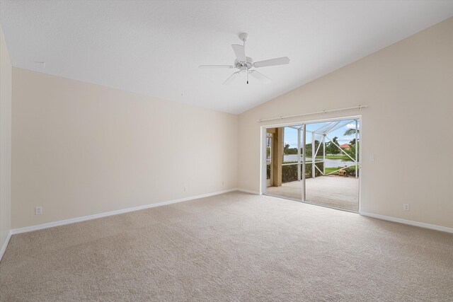 carpeted spare room with vaulted ceiling and ceiling fan