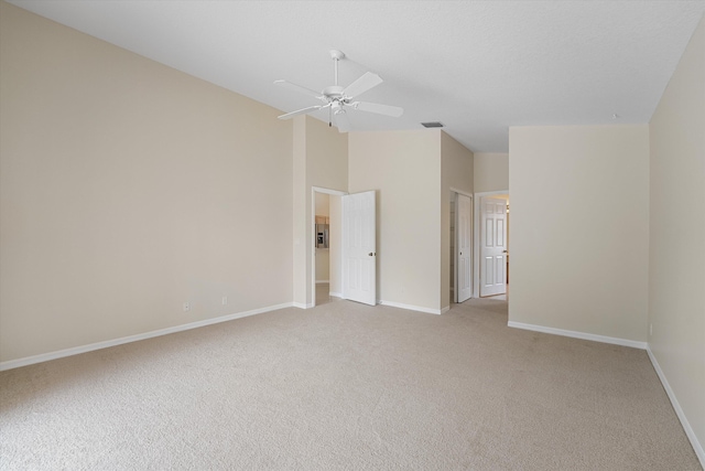 unfurnished room with ceiling fan, light colored carpet, and lofted ceiling