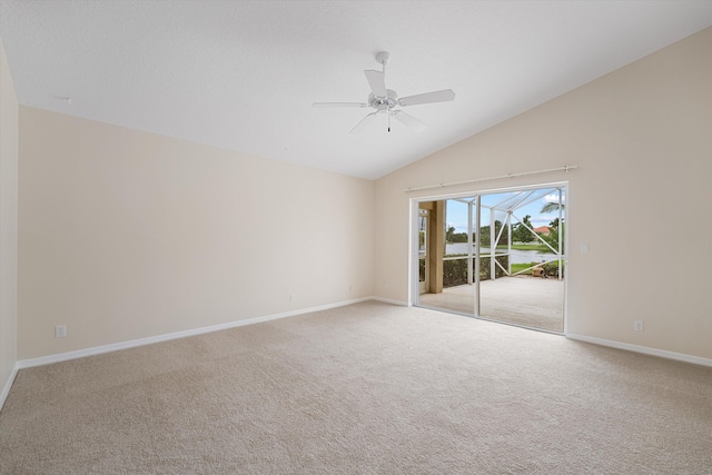 carpeted empty room featuring lofted ceiling and ceiling fan