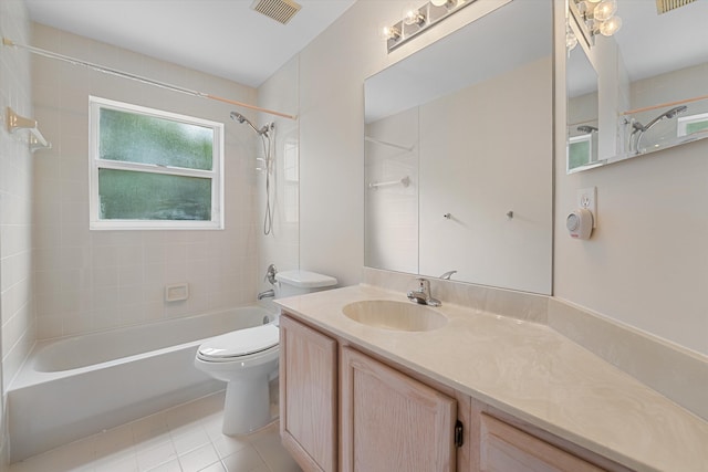 full bathroom featuring tiled shower / bath, vanity, toilet, and tile patterned floors