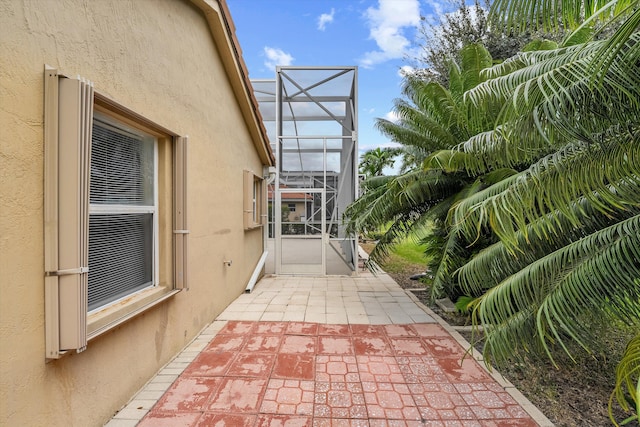 view of patio / terrace featuring glass enclosure