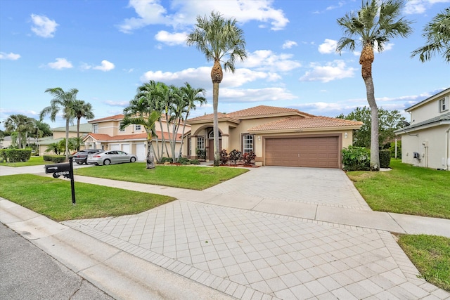 mediterranean / spanish house with a front yard and a garage