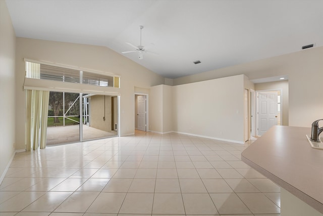 unfurnished room with ceiling fan, light tile patterned flooring, and lofted ceiling