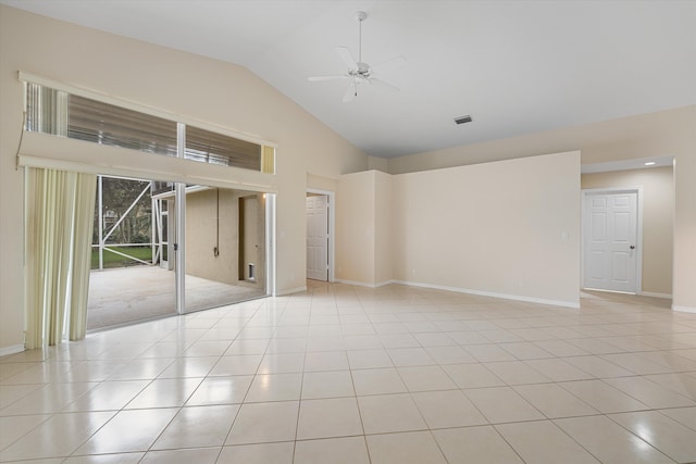 tiled empty room with ceiling fan and high vaulted ceiling