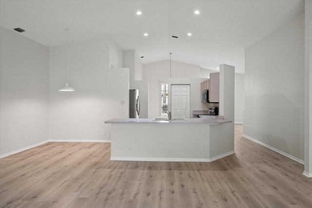 kitchen with sink, decorative light fixtures, light hardwood / wood-style flooring, and appliances with stainless steel finishes