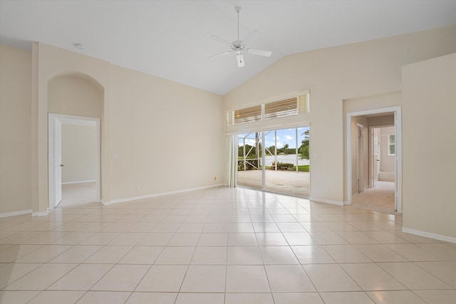 spare room featuring light tile patterned floors, high vaulted ceiling, and ceiling fan